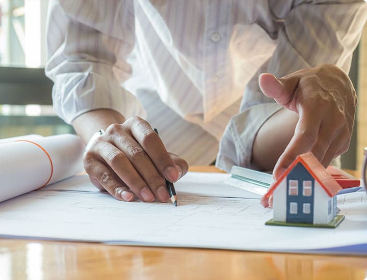 From below of aged stone arch with columns and stucco decorations on wall of ancient building