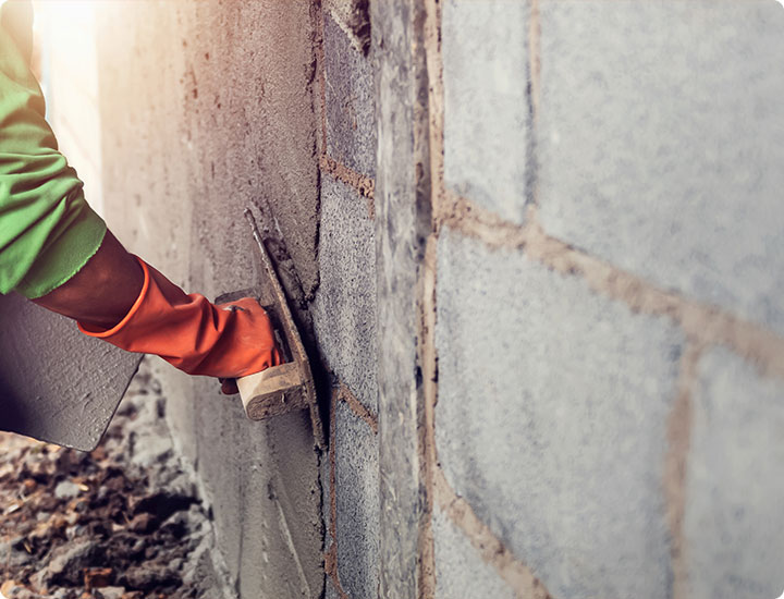 A professional worker sanding the ceiling during a home renovation project. Indoor construction setting.